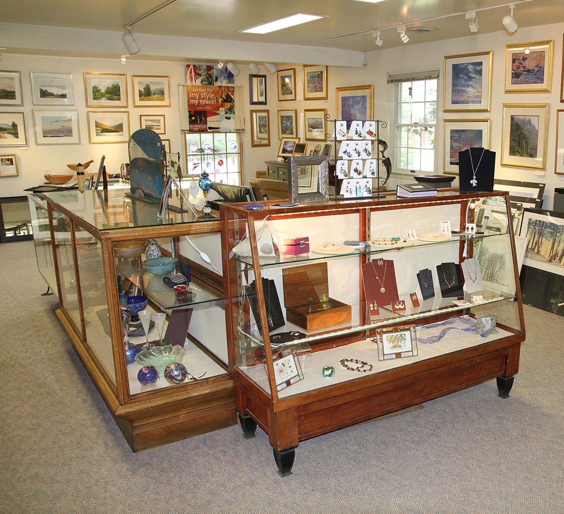 Inside of the Frame Cellar with cases filled with art and jewelry and framed pictures all of the walls