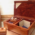 A decorative wooden box with individual items inside of it