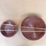 Handcrafted wooden salad bowl with salad serving utensils